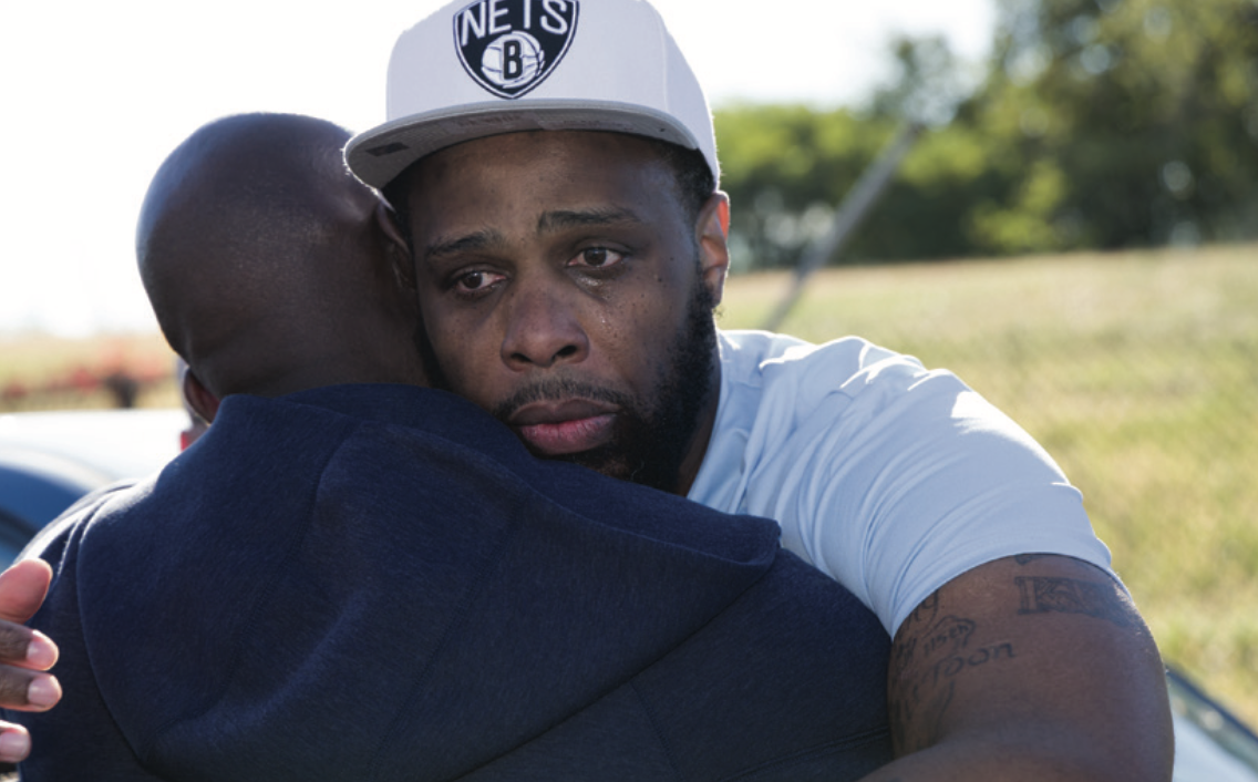 James Comer embracing Christopher White upon his release after more than 25 years incarcerated. / Photo by Steve Hockstein/HarvardStudio.com